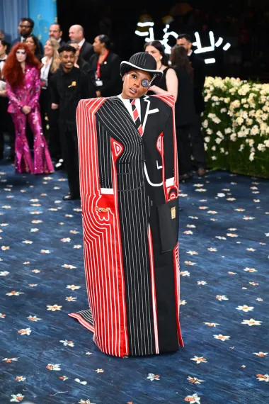 Janelle Monáe pojavila se u dugom sakou s printom koji imitira odijelo i kravatu, uz bowler šešir i monokl, a odabrala je kreativnu suradnju s dizajnerom Thomom Browneom.